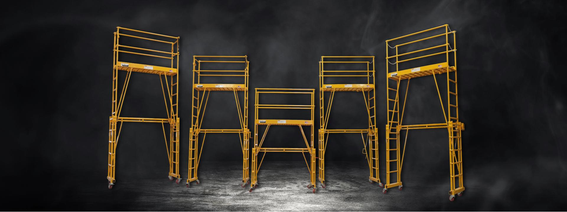 Set of adjustable work platforms arranged in a row on a dark background